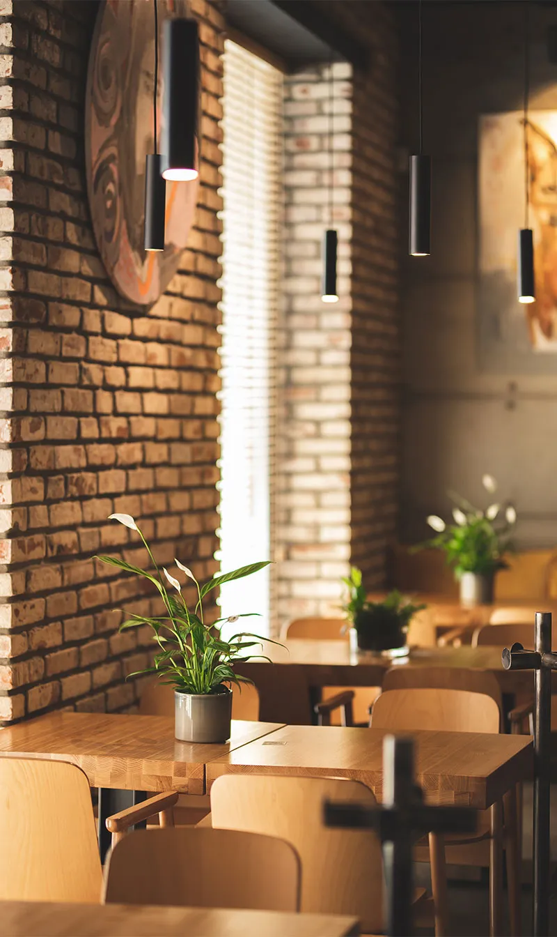 Café interior view of multiple tables and chairs